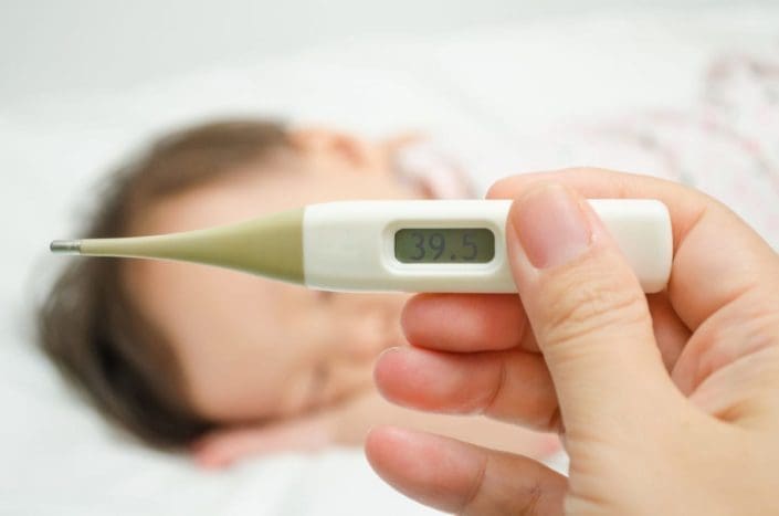 A Young Person Is Holding A Thermometer With High Temperature High