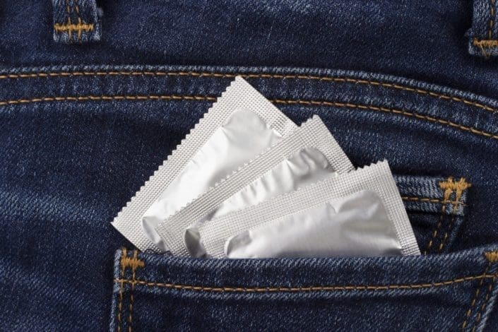 condom packages in a jeans pocket