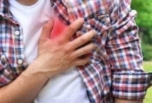 Man holding chest in pain