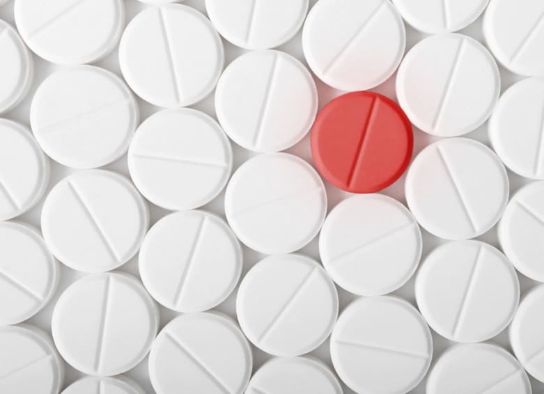 A picture of many pills laid out on a flat surface