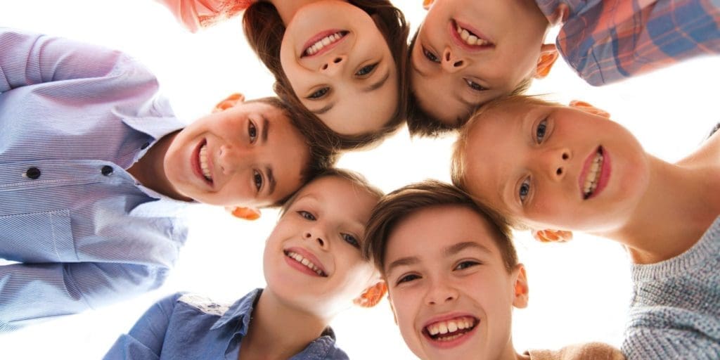 A group of children standing in a circle smile down at the camera. Puberty is the time in life when a child’s body becomes sexually mature. Your child will experience many changes during this time.