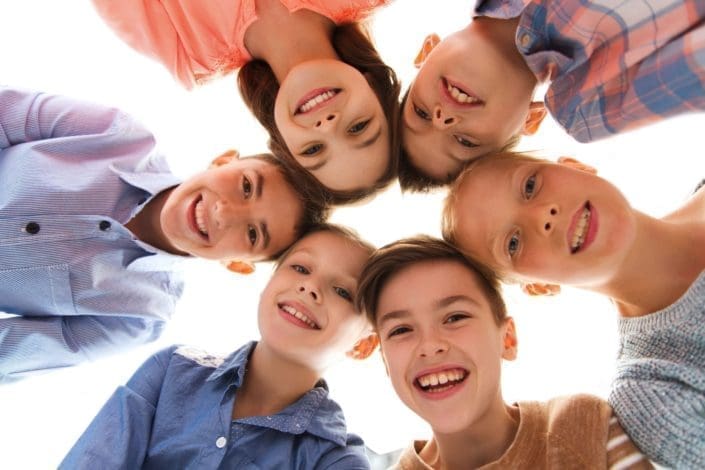 A group of children standing in a circle smile down at the camera. Puberty is the time in life when a child’s body becomes sexually mature. Your child will experience many changes during this time.