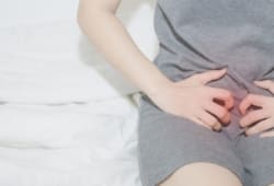 A woman clutching her cervix in pain
