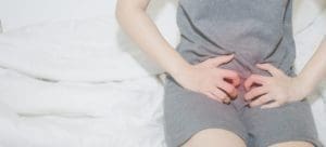 A woman clutching her cervix in pain