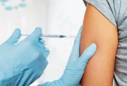 Woman receiving injection in upper arm