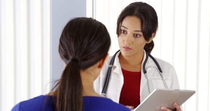 A woman talking to her doctor