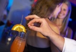 Man Drugging Woman's Drink In Bar