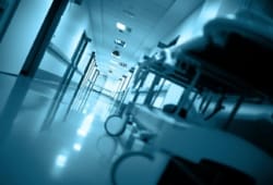 empty gurney sits in a hospital hallway