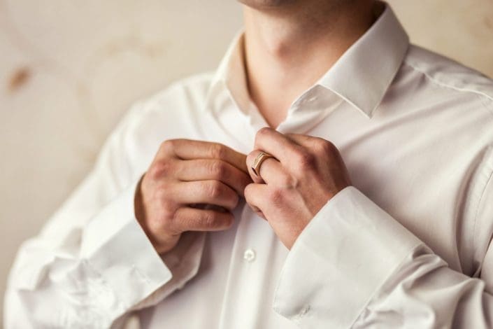 businessman buttoning his shirt