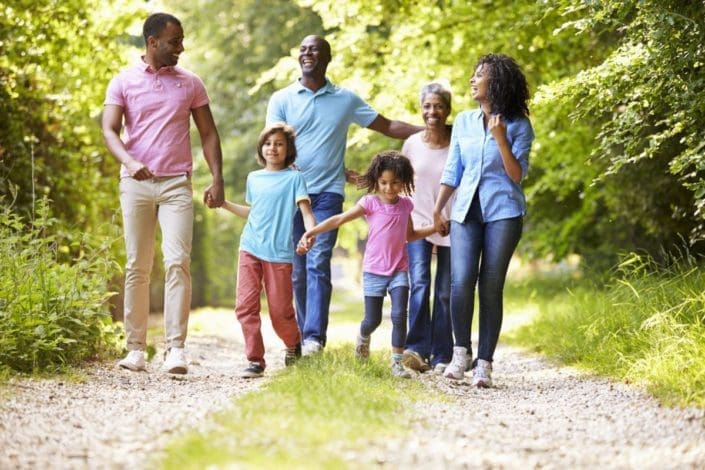 multigenerational family takes a walk on a country road