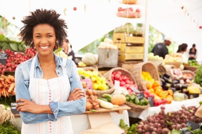 Female stall holder at farmer’s market