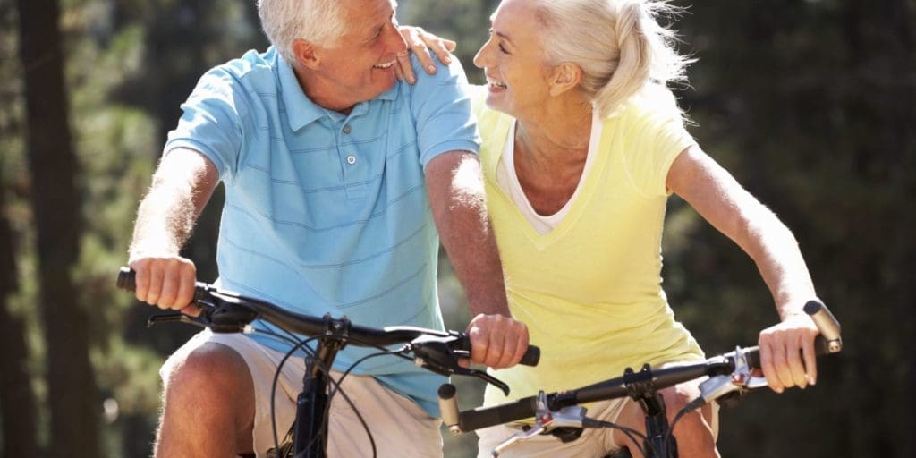 A older couple biking together outdoors