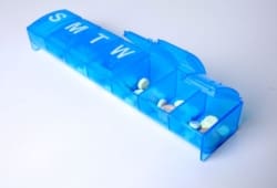 A blue seven-day pill box