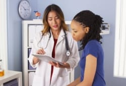 female doctor explains issues to a female patient in a doctor's office