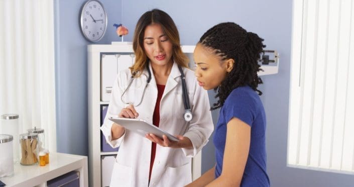female doctor explains issues to a female patient in a doctor's office
