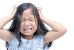 A child scratches her head with a look of discomfort on her face. Head lice are small wingless insects that can get on your hair and scalp. Lice bites may cause scratching, skin irritation or infection.
