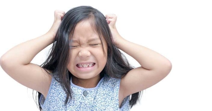 A child scratches her head with a look of discomfort on her face. Head lice are small wingless insects that can get on your hair and scalp. Lice bites may cause scratching, skin irritation or infection.