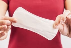 Woman holding clean menstrual pad