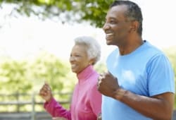 close-up of older couple jogging in a park