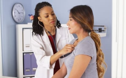 A doctor listens to a patient’s lungs with a stethoscope. Pneumonia is an infection of the lungs usually caused by bacteria or a virus. Walking pneumonia is a mild case of pneumonia.