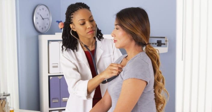 A doctor listens to a patient’s lungs with a stethoscope. Pneumonia is an infection of the lungs usually caused by bacteria or a virus. Walking pneumonia is a mild case of pneumonia.