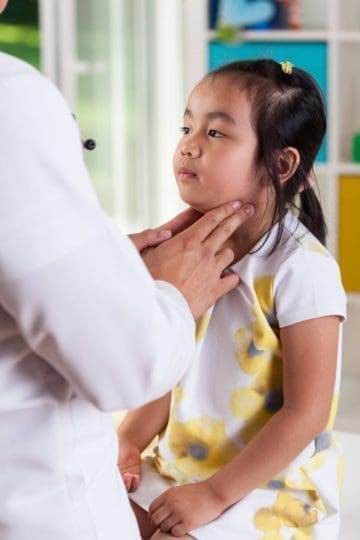 Pediatrician exams a child's lymph nodes. Mumps is a virus that is spread like the common cold. Mumps symptoms can cause you to feel sick for two weeks.