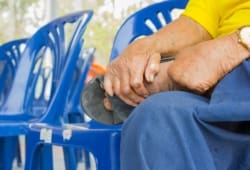 A person sits in a chair and rubs their foot with their hand. Leprosy is a chronic infection caused by bacteria. It can affect the skin, nerves, eyes, and nose. It’s also called Hansen’s disease.