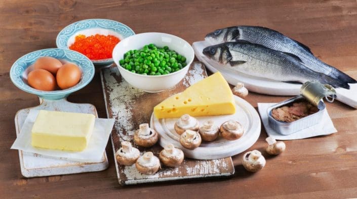 Fish, eggs, dairy products and vegetables sitting on table