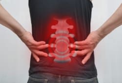View of a man’s spinal column through the back of his shirt