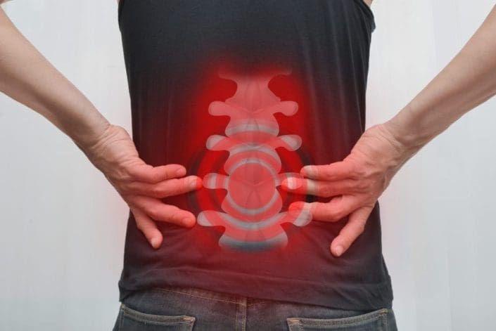 View of a man’s spinal column through the back of his shirt