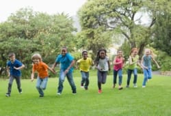 Group of children racing each other in the park