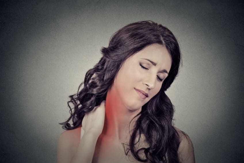 Young woman massaging neck, which is in pain