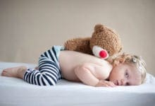 Toddler with chickenpox lying on stomach