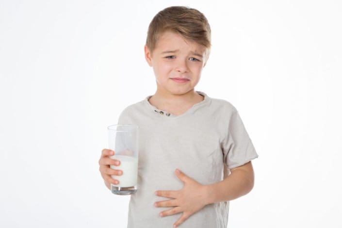 Kid drinking milk & holding stomach