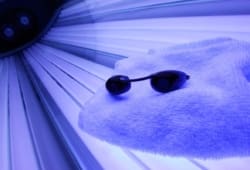 Tanning bed with glasses and towel