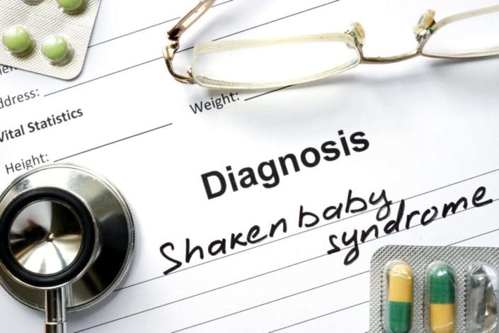 Doctor’s notepad with the words Diagnosis: shaken baby syndrome