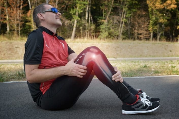 Male runner with knee injury and pain