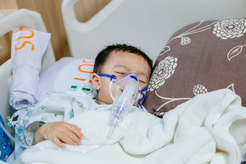 A toddler wears an oxygen mask. RSV (respiratory syncytial virus) is a common virus that makes it hard to breathe. RSV is common in children under 2, but anyone can get it.