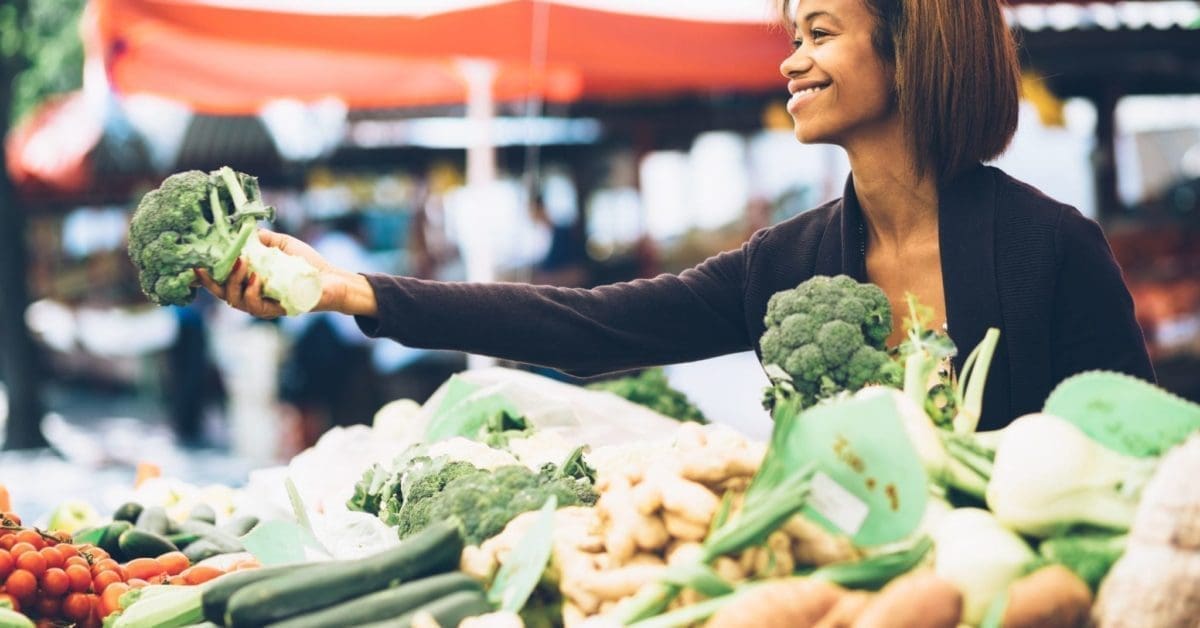 woman buying produce at a farmer's market