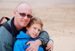 Portrait of father and son outdoors.