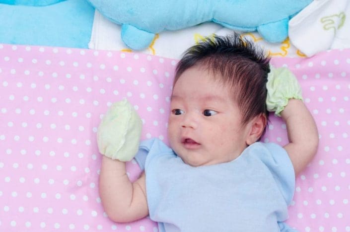 close-up of a newborn baby’s face with a rash