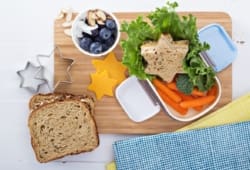 healthy school lunch with star-shaped sandwich, fruit and vegetables