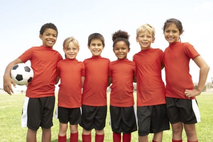 young children pose after playing soccer