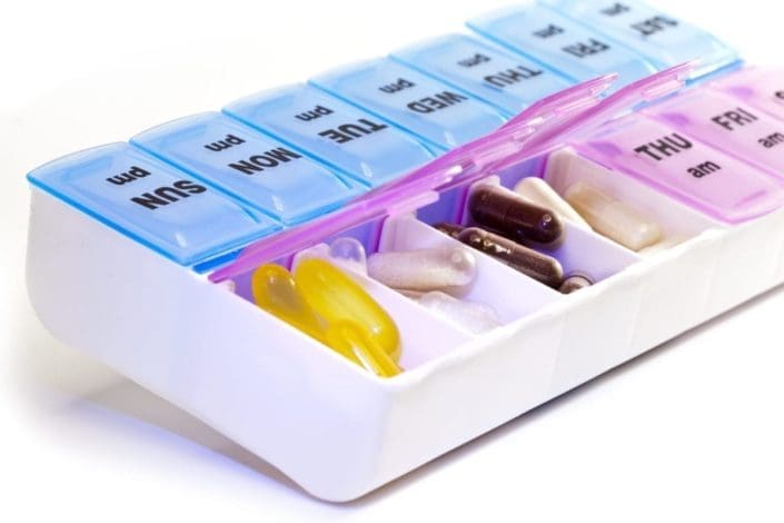 a 2-compartment per day pill organizer with pills