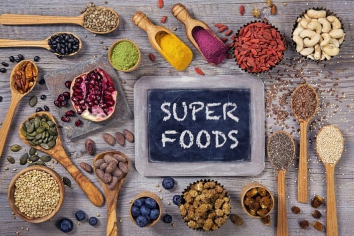 superfoods in bowls and spoons on a table