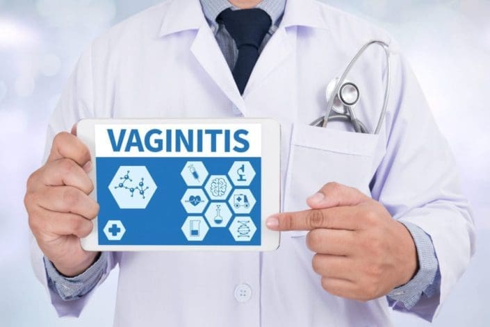 doctor in lab coat holding tablet describing vaginitis