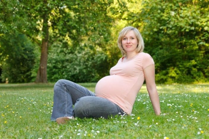 pregnant woman resting in the park