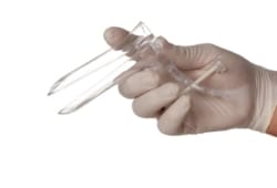 A doctor’s gloved hand holding a disposable speculum