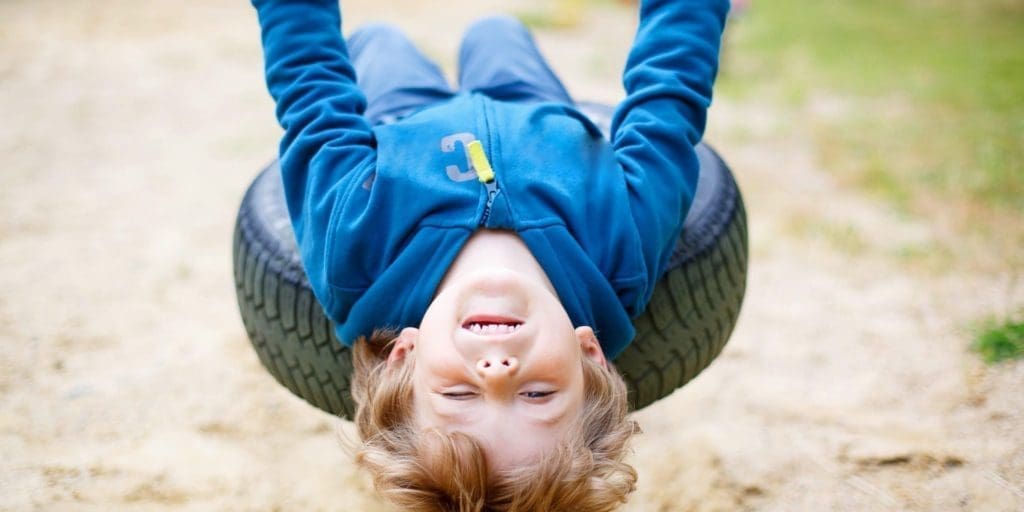 Preschool boy plays on a tire swing, leaning back as far as he can. Sensory processing disorder (SPD) is a condition that affects how your brain processes sensory information (stimuli).