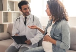 pregnant woman talking to her doctor